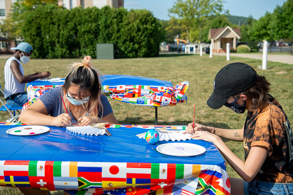 Lawn party guests enjoy painting their own fans, which were needed on a hot late-summer day!