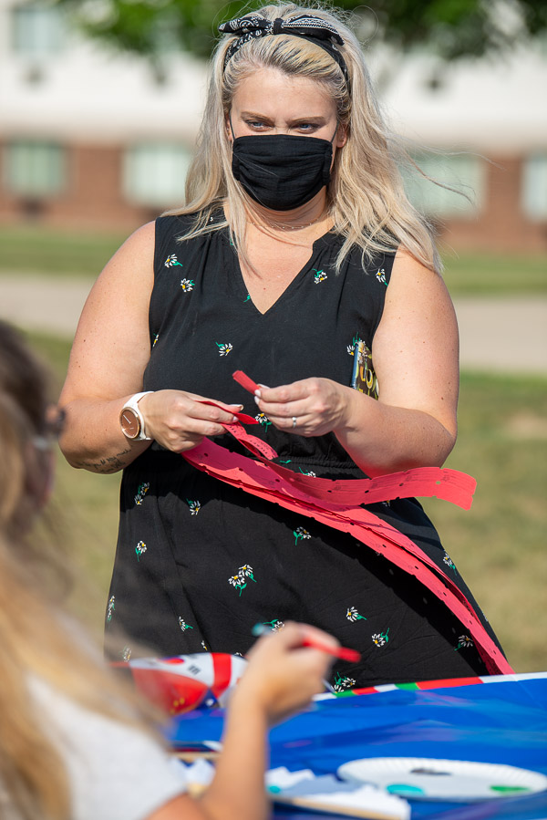 Trisha M. Temple, coordinator of student engagement, distributes coupons for free bubble tea. 