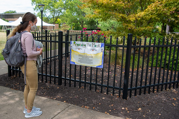 Sabrina J. Martin, nursing, reads one of two signs explaining the exhibit’s intentions.