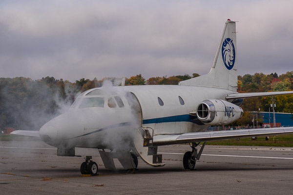 Artificial smoke pours from the Sabreliner, a fixture at the aviation center since its donation by the Air Force.