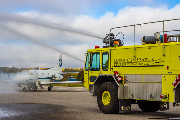 Jets of water shoot from airport-owned apparatus.