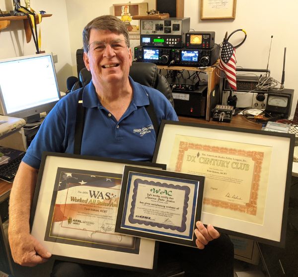 Inman holds the three certificates at his home radio station.