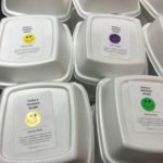 KDR staff puts smiley-face stickers on meal orders to brighten students' day!