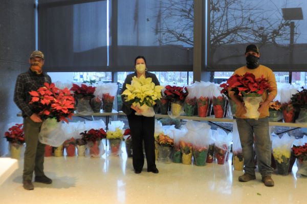 At the end of a whirlwind load-in, Forest, Watts and Avery (from left) show off the seasonal color about to be shared with hundreds of deserving caregivers.