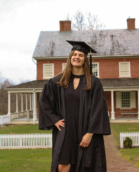 Strubel, among Penn College's Fall 2020 graduates, poses in her cap and gown at Historic Rock Ford in Lancaster.