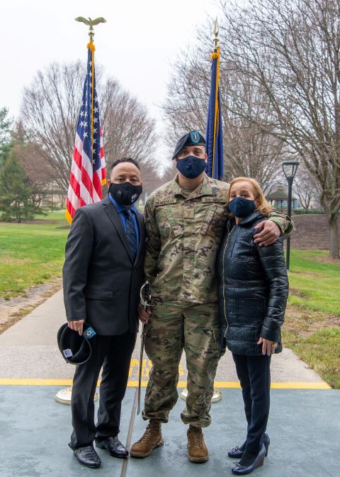 Placencia, termed "the nation's newest leader" during the morning ceremony, marks the occasion with his mother, Ana Coste, and brother, Frank Coste. He is holding an Army sword, presented this year as Penn College's first Patriot Award.