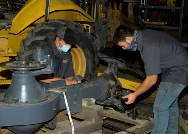 Pennsylvania College of Technology students Quinton S. Leonard (left), of Palmyra, and Josh R. Werni, of Lebanon, work on one of four Terex Corp.-donated drive axles in instructor Chris S. Weaver's Powertrain and Brake Systems lab. Both are enrolled in heavy construction equipment technology: technician emphasis.