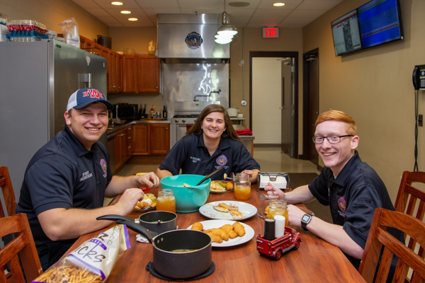Strubel enjoys "family dinner night" at the Montoursville fire station last year with Jared A. Stewart (left), of Waverly, N.Y., '20, emergency medical services and paramedic technician; and Matthew C. LaRock, of Chemung, N.Y., '20, emergency medical services. 