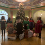 Joining the college contingent on the receiving end are Brittany Fischer (center left), YWCA communications and development director, and CEO Dawn Linn (center right). (Photo provided)