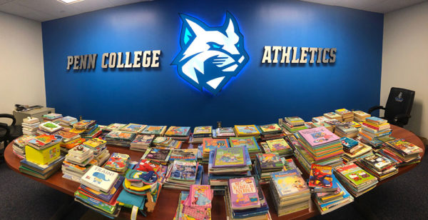 Hundreds and hundreds of books were collected in the Wildcat Athletics office for delivery to local children.