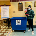 Lacey A. Decker, of Emporium, a dental hygiene student who works part time as an information desk assistant for the Office of Student Engagement, stands by the Bush Campus Center collection bin ...