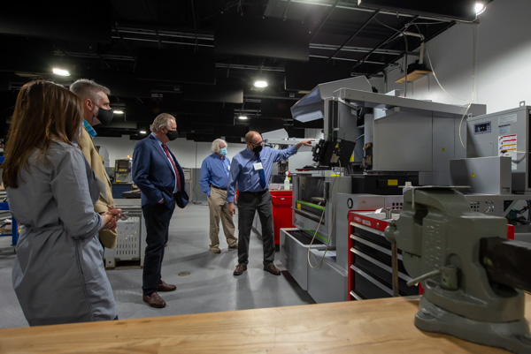 Troup (right) escorts a small group through the renovated space, sharing his expertise about the array of equipment.