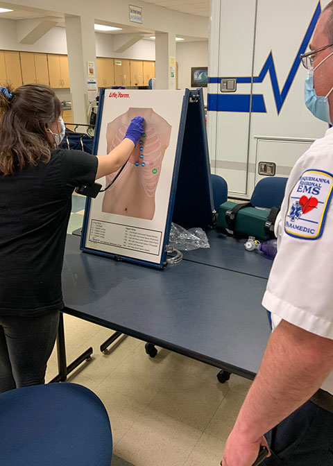 Student Aleyah D. Walter, of Hughesville, uses a Smartscope that produces a specific lung sound when placed against a preprogrammed "torso." The simulator, purchased through a PPL Foundation grant and based at Pennsylvania College of Technology's Wellsboro campus, can mimic a variety of symptoms and easily be transported to other training venues. At right is Timothy A. Weaver, noncredit instructor for basic life support and a 2011 Penn College alumnus in emergency medical services.