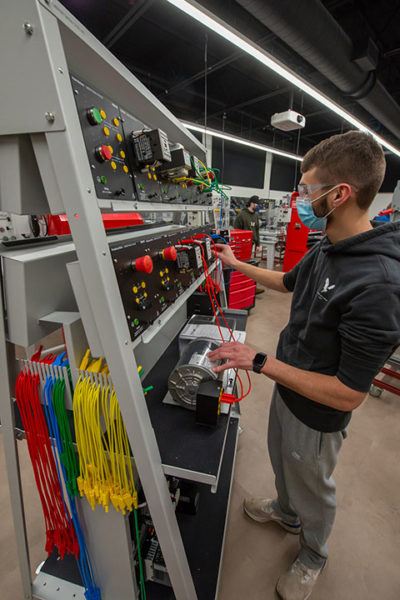 In a mechatronics lab at Pennsylvania College of Technology, student Andrew C. Caffrey gains industrial electricity skills at a portable, modular trainer featuring components purchased with PPL grant funds. Caffrey, of Denver, Pennsylvania, is enrolled in automation engineering technology: mechatronics.
