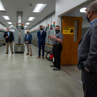 Art L. Counterman (second from right), instructor of electrical technologies and occupations, leads Argall (right) and the group through the Electrical Technologies Center. Among those taking part was recent graduate Ethan M. McKenzie (to Counterman's right), soon to begin serving a fellowship in the College Relations Office.