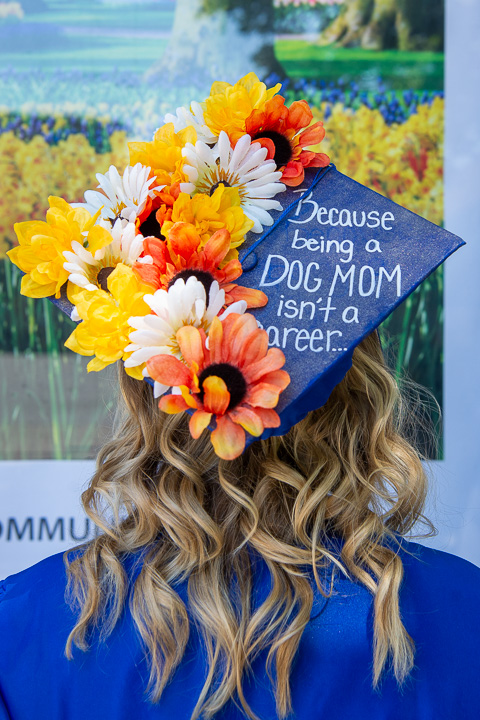 The flowering headpiece of pet lover Madison P. Clark, graduating with high honors in early childhood education, adds dimension to a Community Arts Center poster ...