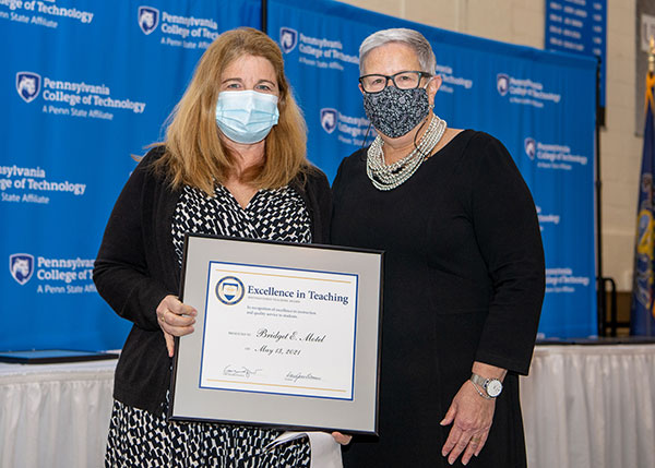 Bridget E. Motel (left), instructor of dental hygiene, is presented with an Excellence in Teaching Award by the president.