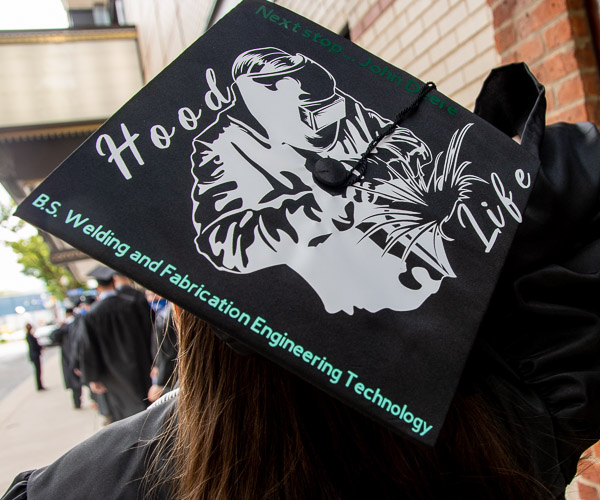 The cap of Barbara J. LeGeyt, a welding and fabrication engineering technology graduate from Barkhamsted, Conn., shows yet another “maker” skill. Her next stop? Working for John Deere.