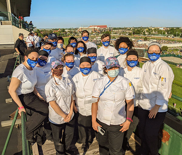 Penn College culinary and baking and pastry arts students celebrate a week of long hours and invaluable industry experience in the kitchens of Churchill Downs during Kentucky Derby Week by watching the headline race from the rooftop.
