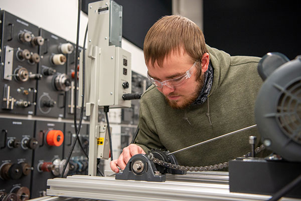 Thomas L. Snyder, of Weedville, employs hands-on skills in Pennsylvania College of Technology’s mechatronics lab. Snyder, who graduates with an associate degree in mechatronics technology on May 16, has strong family roots at the institution. 