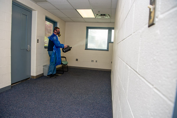 Thomas C. McNamee, first-shift custodian/floater, fogs the College Health Services annex, the CC's dedicated site for COVID-19 testing.
