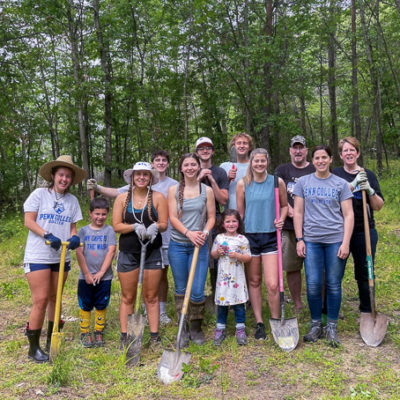Students join program staff and family members in a planting project at Trailing Pines Tree Farm in Muncy.