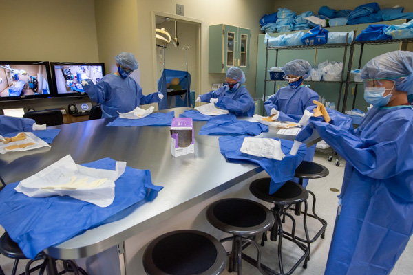 Preparing for surgery? Campers learn to navigate the complexities of the operating room, including “gowning up” in the surgical technology lab.
