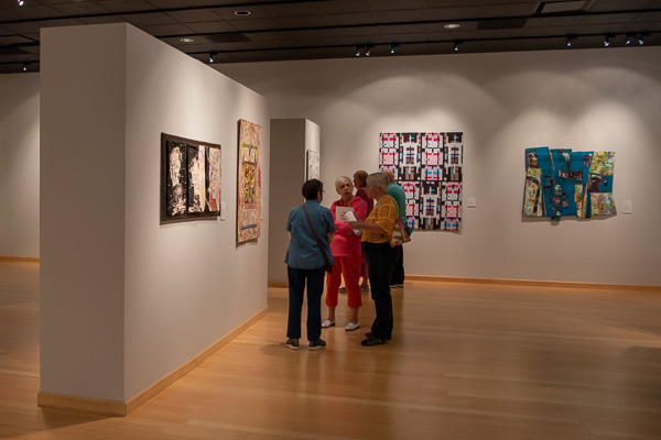 Gallery-goers engage in conversation …