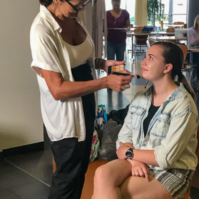 Wiest receives attention from a hair and makeup artist. 
