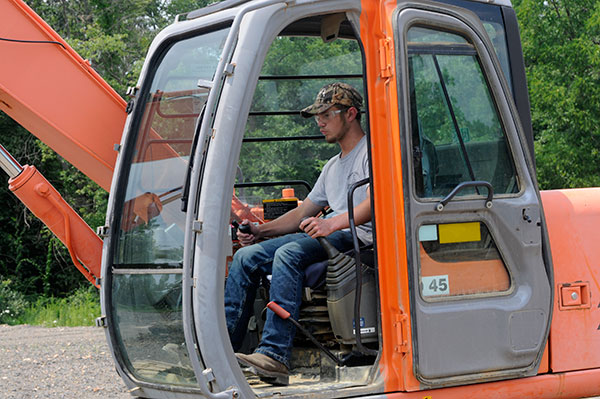 At the controls of an excavator, it's hands-on all the way!