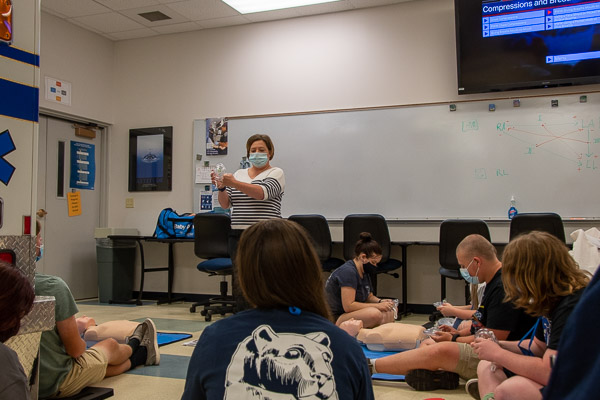 Kathy L. Kling, a 2015 Penn College grad and an instructor of basic life support (EMT/EMR) for the college, as well as a paramedic for Susquehanna Regional EMS, explains the pocket mask used to administer CPR before participants try theirs.