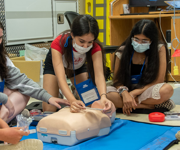 A high schooler in Fundamentals of Emergency Response places the patch for an automatic electronic defibrilator, also part of the training in the college’s paramedic labs.