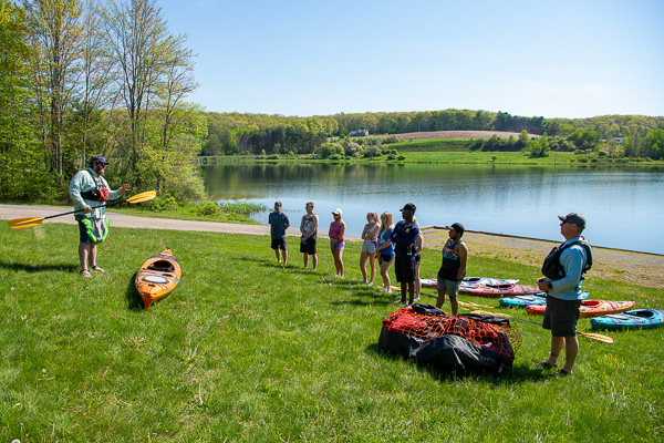 The kayakers undergo a safety demonstration by Jae Ellison, director of outdoor learning and education at Lycoming College ... 
