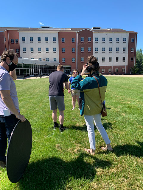 The crew – including Mercy, during her last day on campus – films outside Dauphin Hall.