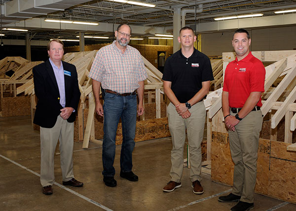 The group also stopped in other instructional areas where students are eligible for scholarship assistance, joining Peter Kruppenbacher (second from left), assistant professor of building construction technology, in the building construction and concrete science labs.
