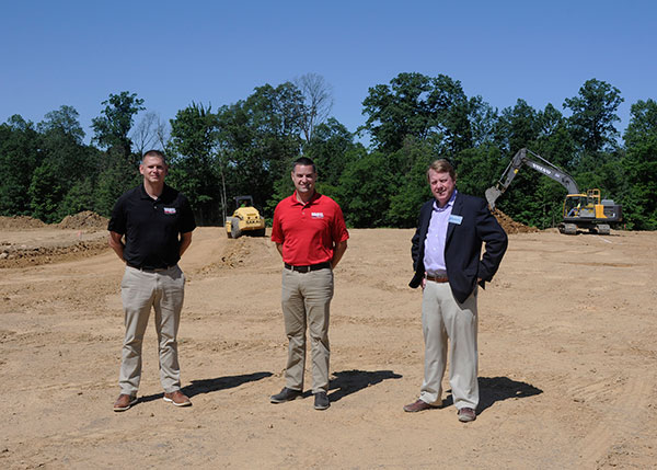 Craig M. Hartz (left), director of field operations at Warfel Construction, and Pennsylvania College of Technology alumnus Brad A. Shulenberger (center), Warfel's vice president of construction services, visit the heavy construction equipment operations site in Brady Township with Chris S. Macdonald, the college's assistant director of corporate relations.
