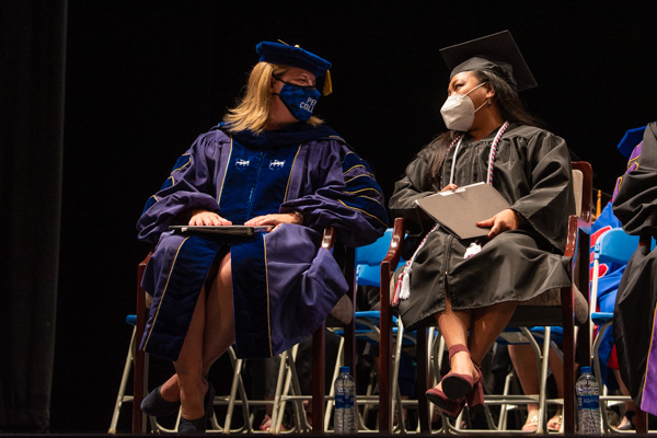 The student speaker (right) talks with Carolyn R. Strickland, vice president for enrollment management/associate provost.