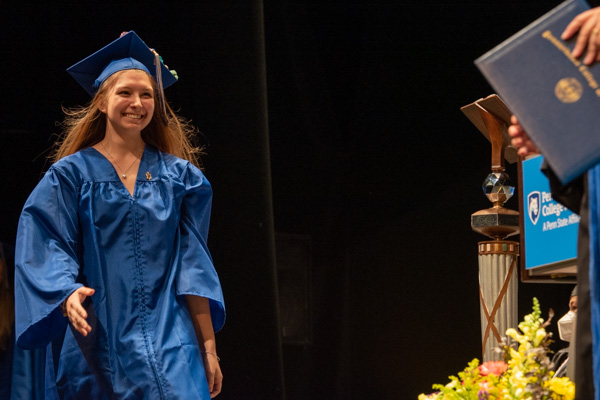 Striding joyfully toward her moment is Lauren M. Swavely, an occupational therapy assistant graduate.
