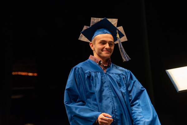 Radiography grad Brent M. Kile, of Millville, adorned his headgear with photographs.