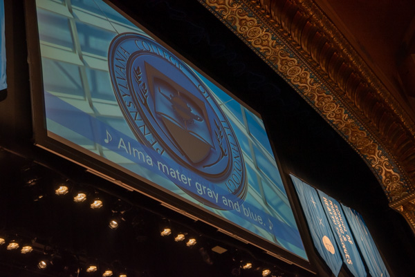 On-screen lyrics guide graduates through the vocal remembrance of their "proud Penn College days."
