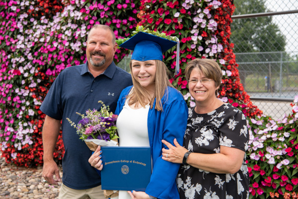 Emily E. Longenecker – a Hummelstown resident who graduated in physical therapist assistant – makes a memory with her parents.