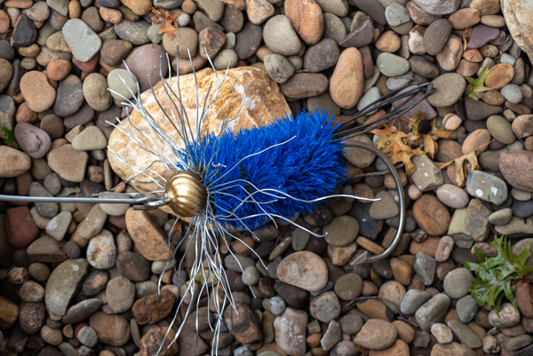 A fly-fishing lure adds an authentic touch to a faux creek bed.