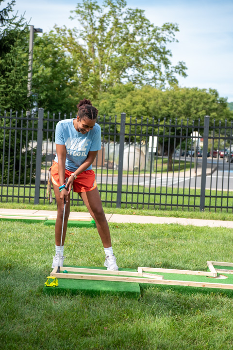Normally at home on the basketball court, Wildcat athlete Ja’Quela Dyer, of Dover, Del., lines up a putt. 