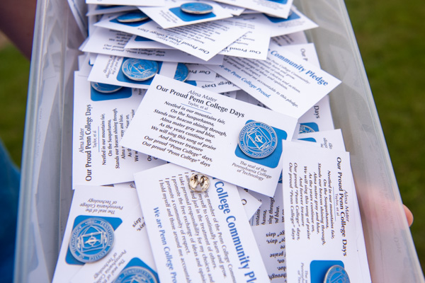 Students were given college pins affixed to cards featuring the Penn College Community Pledge and lyrics to the alma mater. 