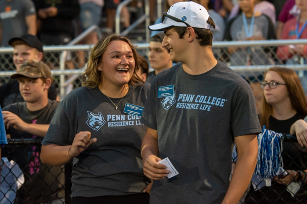 Resident assistants Christine A. Limbert, of Curwensville, and Andy P. Luzeckyj Jr., of Southampton, exuberantly finish singing the alma mater. 
