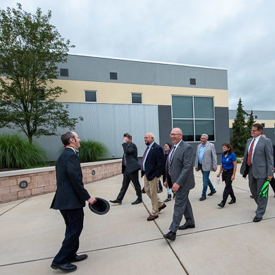 Webb leads visitors – including Wheeland (front row, center), the county's other representative – to College Avenue Labs.