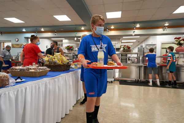 Toting a trayful, one of more than 1,200 prepared for the teams during the series by Penn College’s culinary, baking and pastry arts majors
