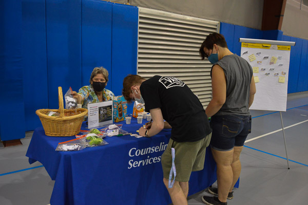 Counseling Services' Linda L. Locher interacts with students at the event, which was moved indoors due to a threatening forecast.