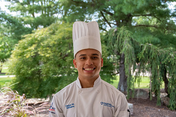 Penn College culinary arts student Darius M. Williams, of Williamsport, is among those helping to prepare food for Little League World Series teams at the Little League International Complex.