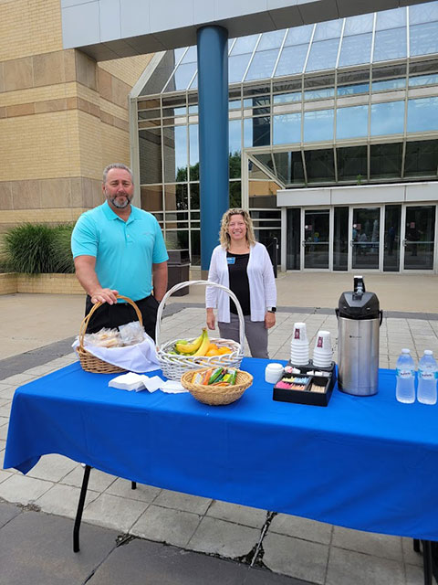 Offering collegial support outside the Breuder Advanced Technology & Health Sciences Center on Monday morning are baseball coach Chris H. Howard and counselor Michelle L. Finn.